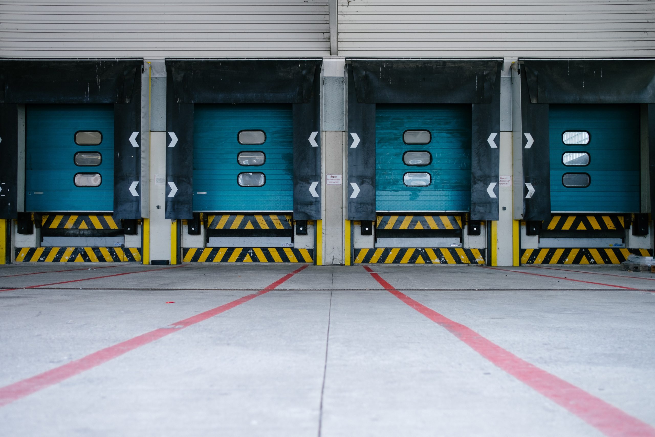 Types of Industrial Real Estate to Add to an Investment Portfolio. Image of the closed bay doors of an industrial building.