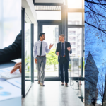 Property Data, Tenant Retention, and CRE Liquidity. Image of a person typing on a laptop while holding a pen and using a calculator on top of printouts of graphs (left), two people talking to each other while walking in a building (middle), and buildings in Uptown Charlotte, NC (right).